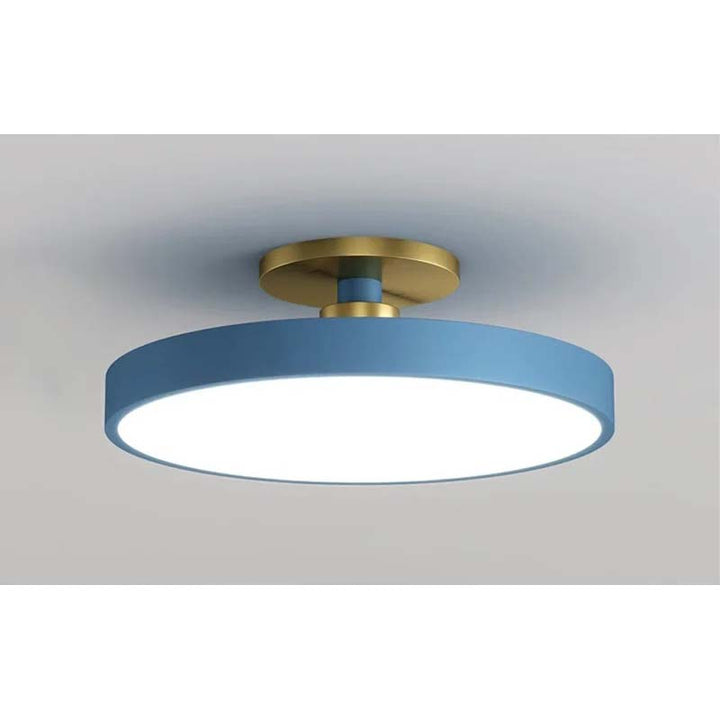 Ceiling light fixture with blue shade and gold fixture on a gray background