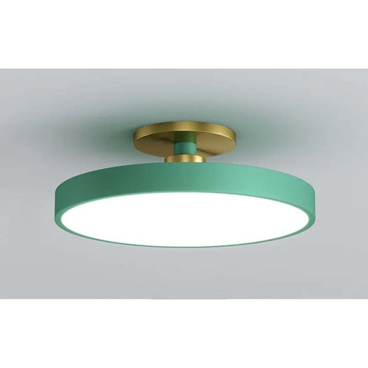 Ceiling light fixture with green shade and gold fixture on a gray background