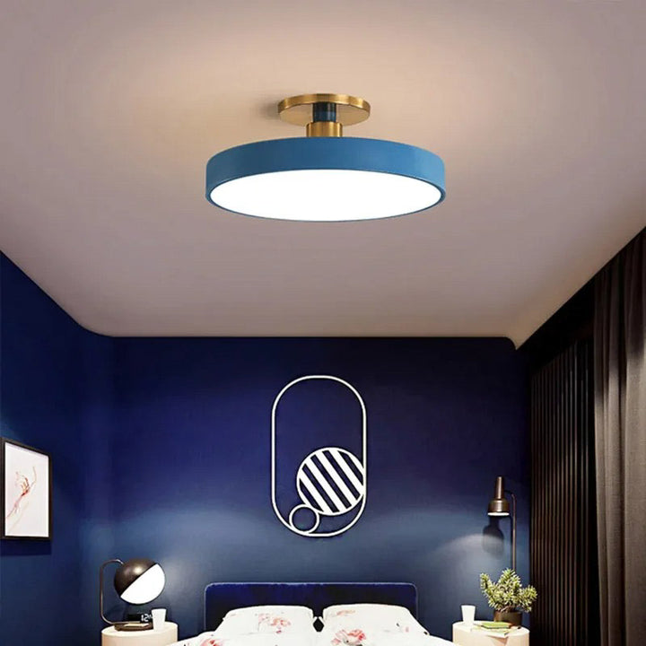 Ceiling light fixture in a bedroom with blue and gold design