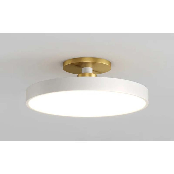 Ceiling light fixture with white shade and gold fixture on a neutral background