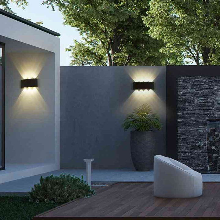 Two black aluminum modern LED wall lights on outdoor walls, providing architectural glow for the patio.