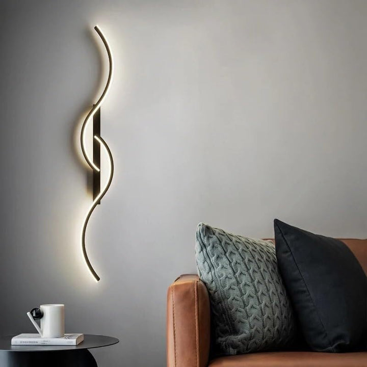 Contemporary LED wall light in black, mounted in bedroom for ambient night-time lighting