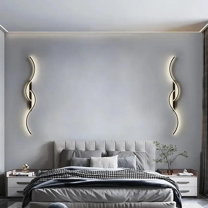 Pair of sculptural LED wall lamps used as symmetrical bedroom lighting, ideal for modern UK homes