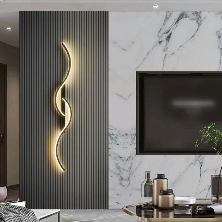 Contemporary black and gold LED wall light installed on marble feature wall, perfect for luxe living rooms