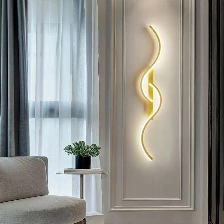Elegant LED wall sconce in soft gold tone beside window, ideal for Scandinavian-inspired hallways or living spaces