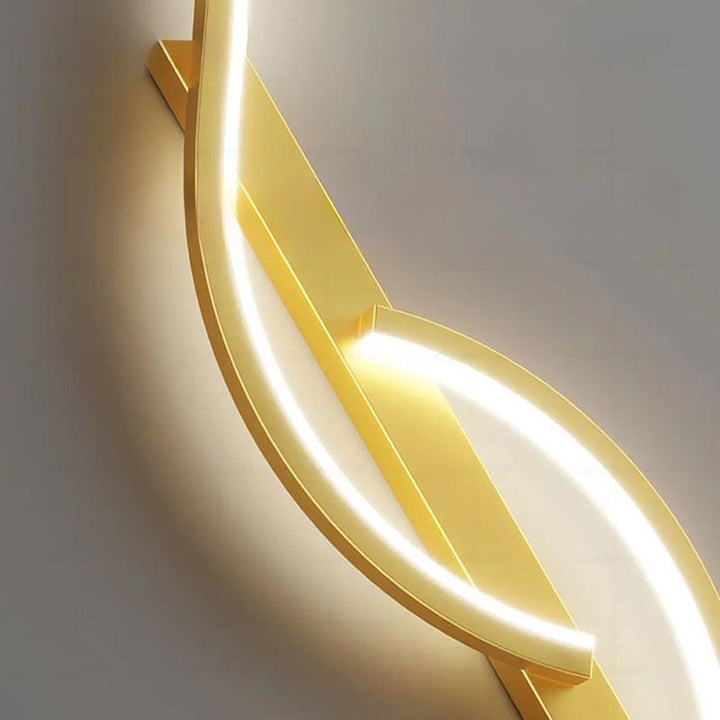 Sculptural gold LED wall sconce with soft ambient light, premium aluminium frame and acrylic diffuser