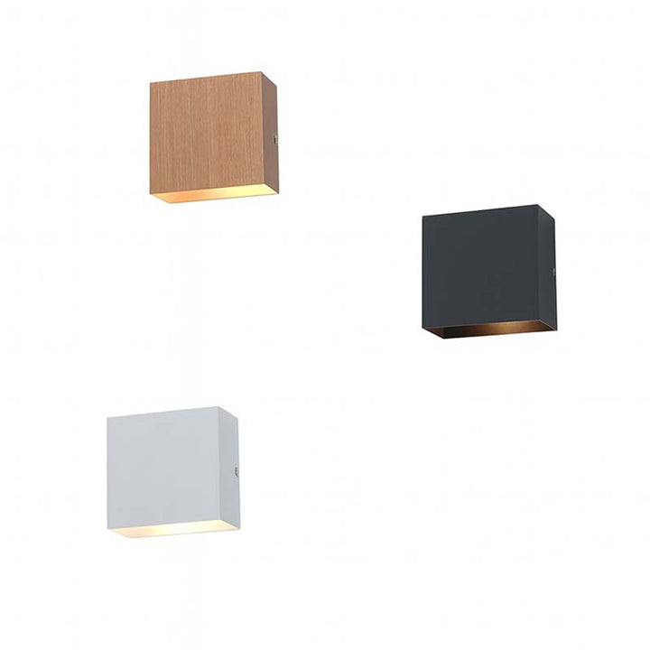 Three square wall lights in different colors on a white background