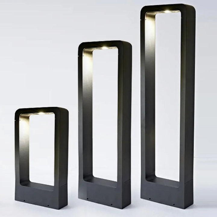 Three black rectangular modern LED outdoor lamps of varying heights on a white background