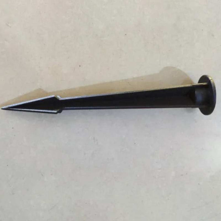 Metal tool with a pointed end on a light gray background