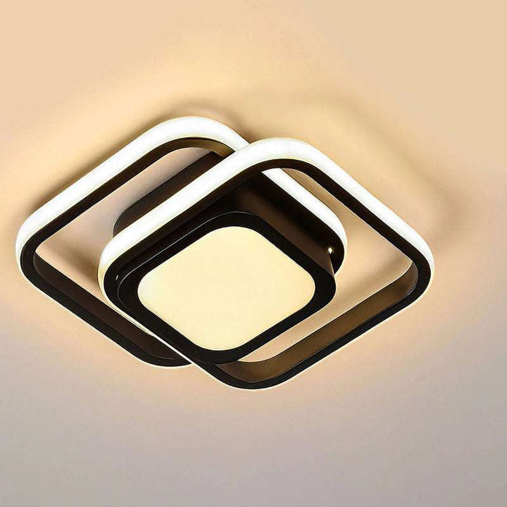 Close-up of black square double frame LED ceiling light with warm illumination
