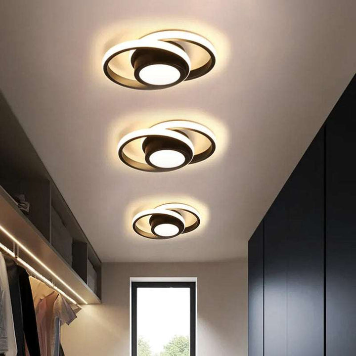 Closet ceiling with black double ring LED lights providing warm ambient glow