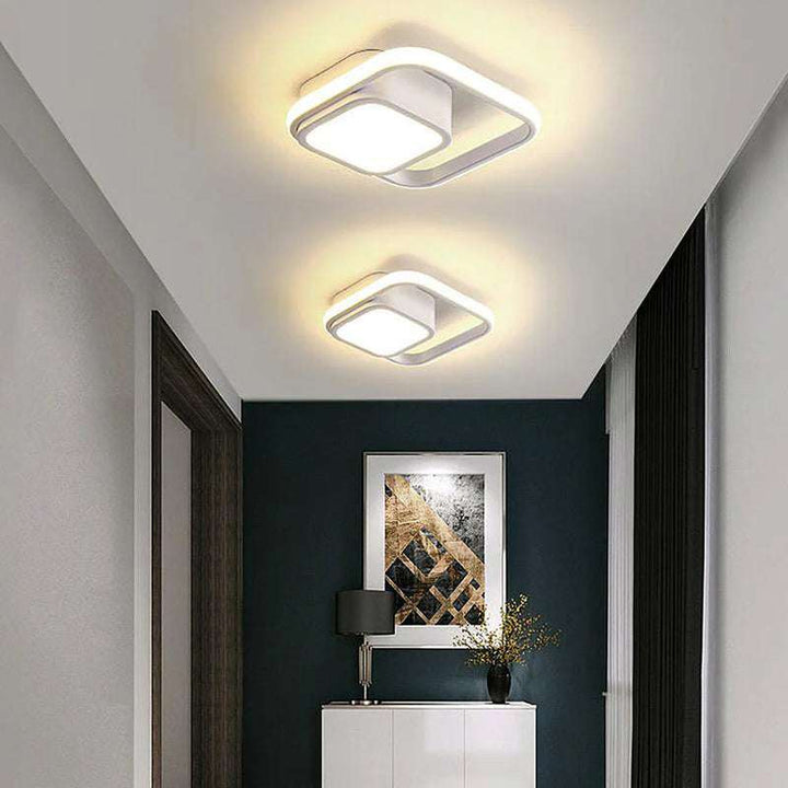 White square LED ceiling light with dual frame design in minimalist hallway décor