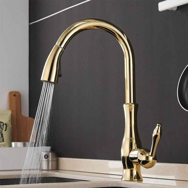 Gold kitchen faucet with water flowing in a modern kitchen setting