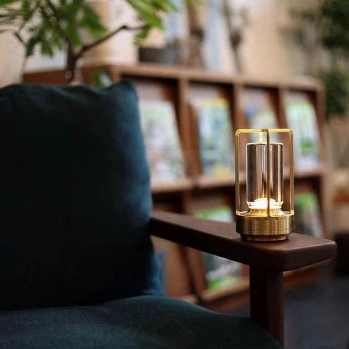 Black LED lamp on wooden armrest, compact modern light for living rooms and reading nooks.
