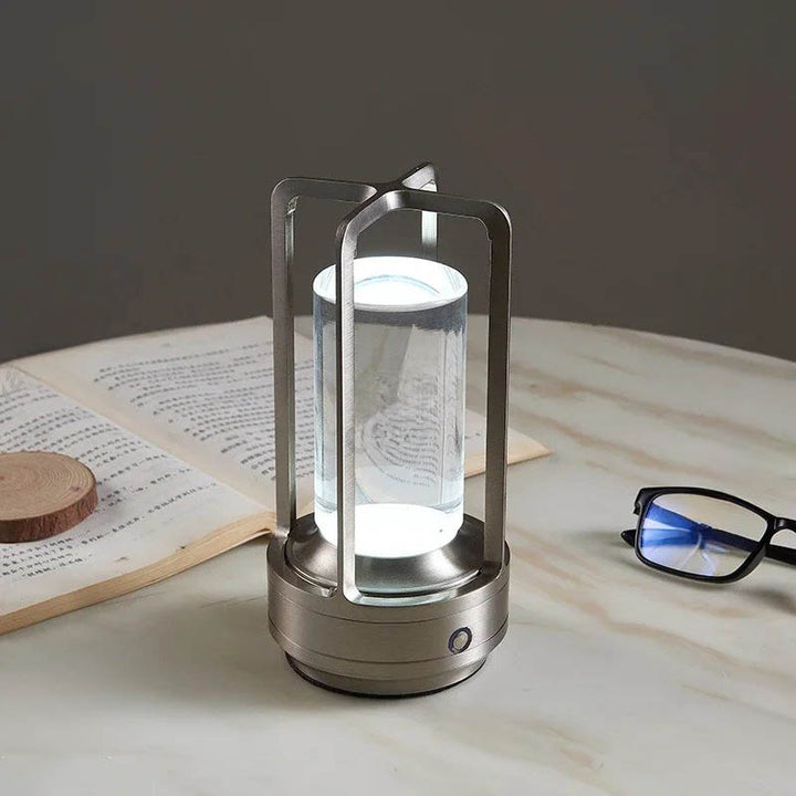 Silver modern Rechargeable lighjt with cool white glow, perfect for reading or ambient desk lighting.