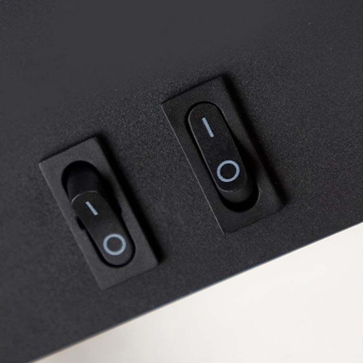 Two black toggle switches on a dark gray surface.