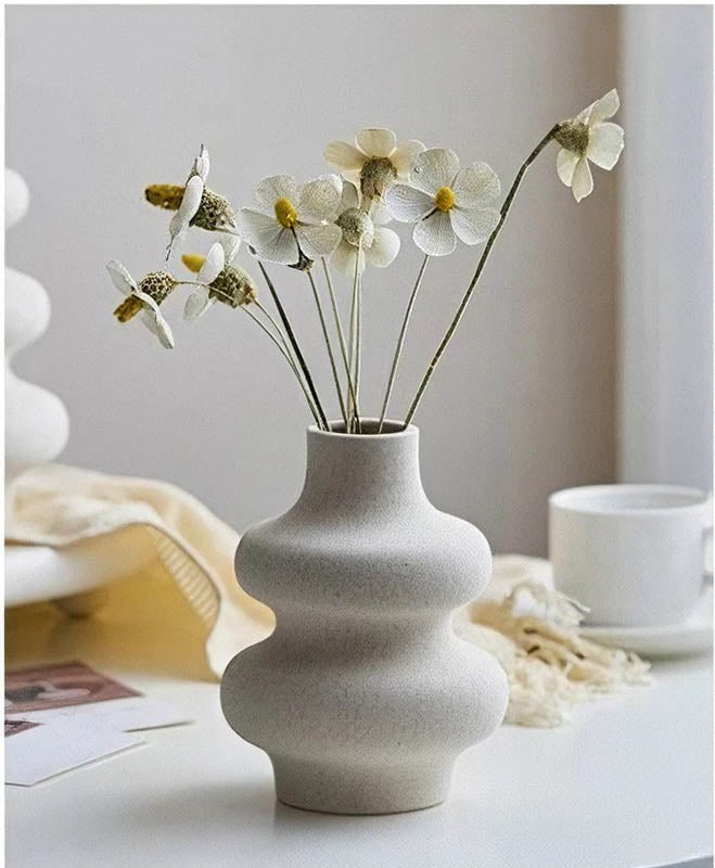 Short VIT ceramic vase with modern beige finish on table with book and coffee cup