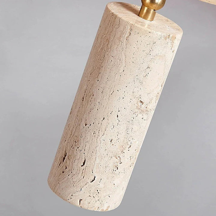 Decorative lamp with stone base and gold fixture on a gray background