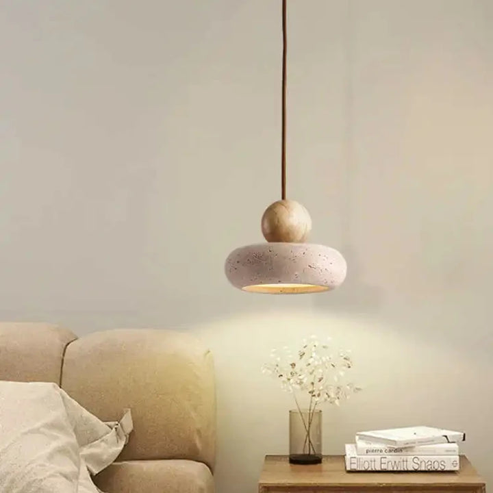NATUR vintage pendant light with natural stone design hanging above beige sofa in cozy bedroom