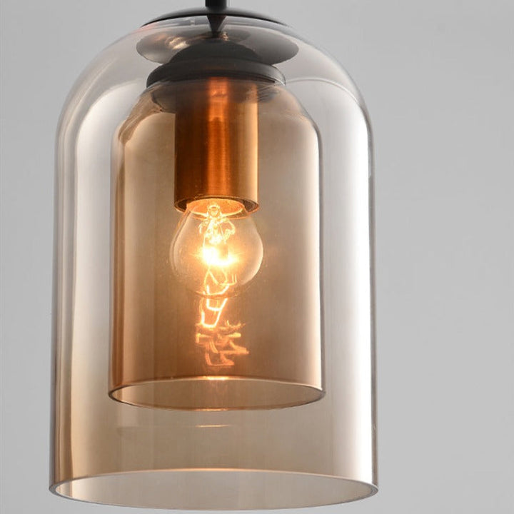 Close-up of smoked glass pendant light with glowing bulb