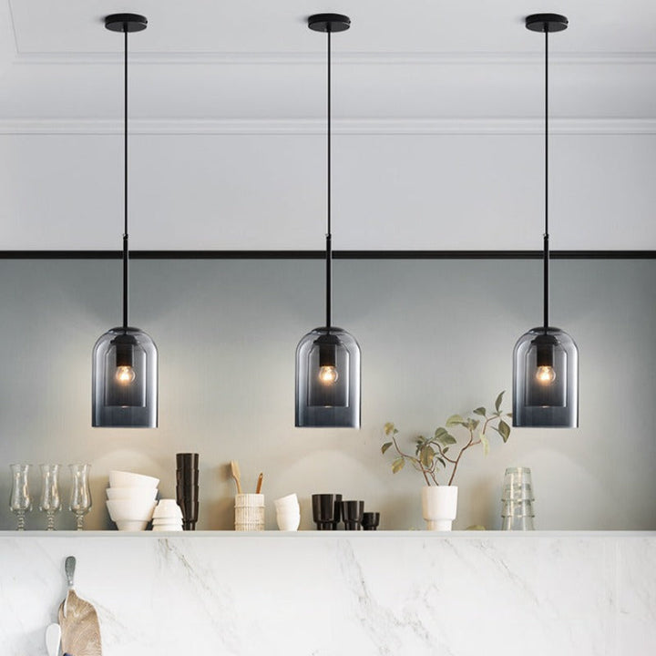 Trio of smoked glass pendant lights in a modern kitchen
