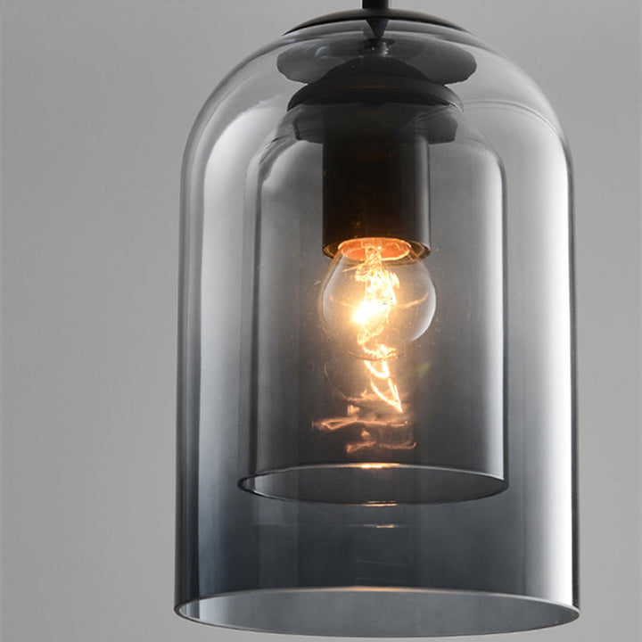 Close-up of an amber glass pendant lamp with glowing bulb