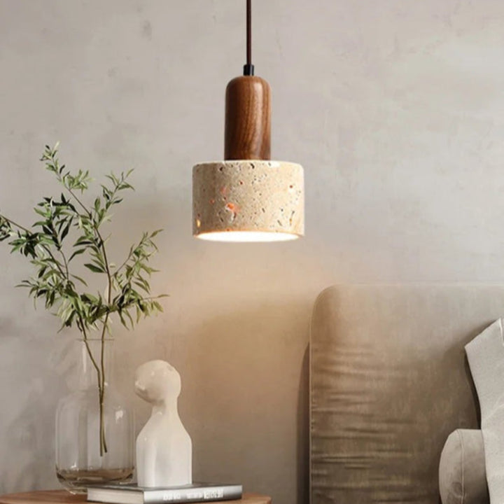 Natural Stone Pendant light fixture hanging above a table with decorative items in a room setting.