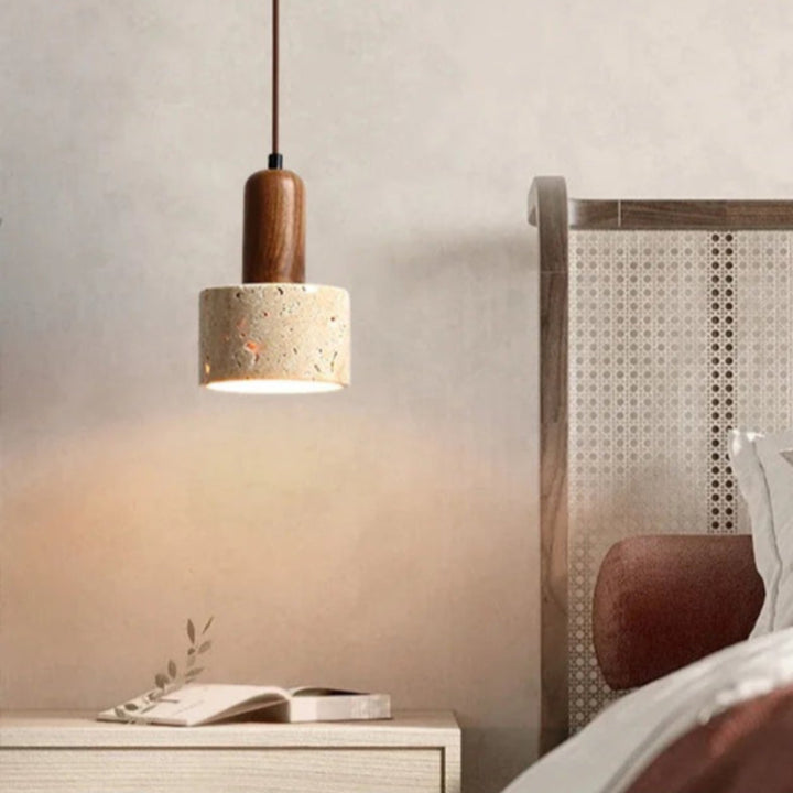 Natural Stone Pendant light fixture in a bedroom setting with a wooden base and concrete-like shade.