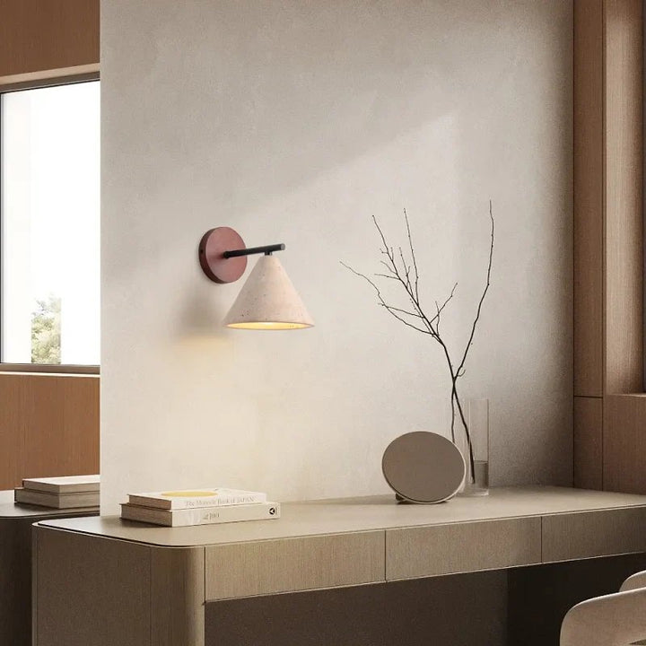 Yellow travertine wall sconce with warm LED glow styled above modern oak desk in Scandinavian-inspired interior.
