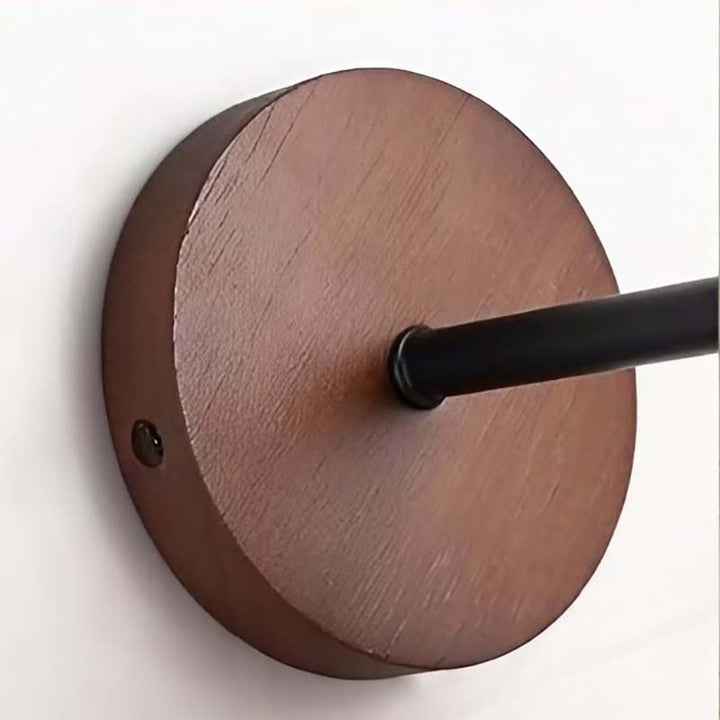 Wooden wall-mounted light fixture with black arm on a white background
