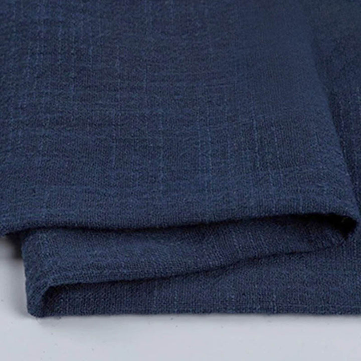 Folded navy blue cotton napkin for Weddings and Elegant uk Dining Decor on the white table.
