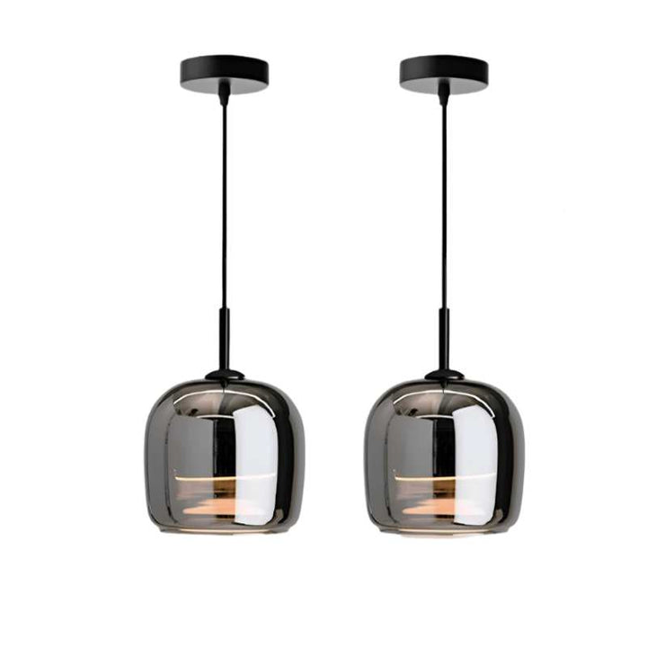 Two modern pendant lights with smoked glass shades on a white background