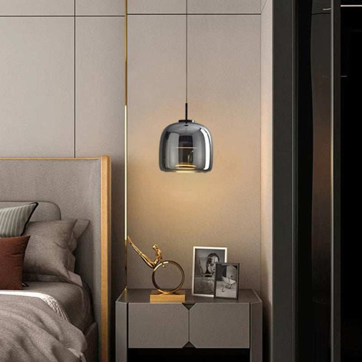 Modern bedroom with a bed, nightstand, and nordic glass pendant light.