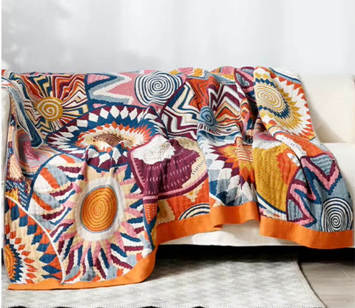 Medium Nordic cotton throw blanket, soft woven comfort, colorful abstract pattern on sofa