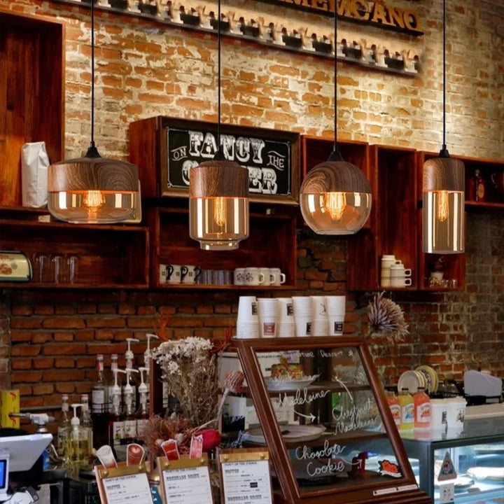 Interior of a coffee shop with brick walls, hanging lights, and a counter display.
