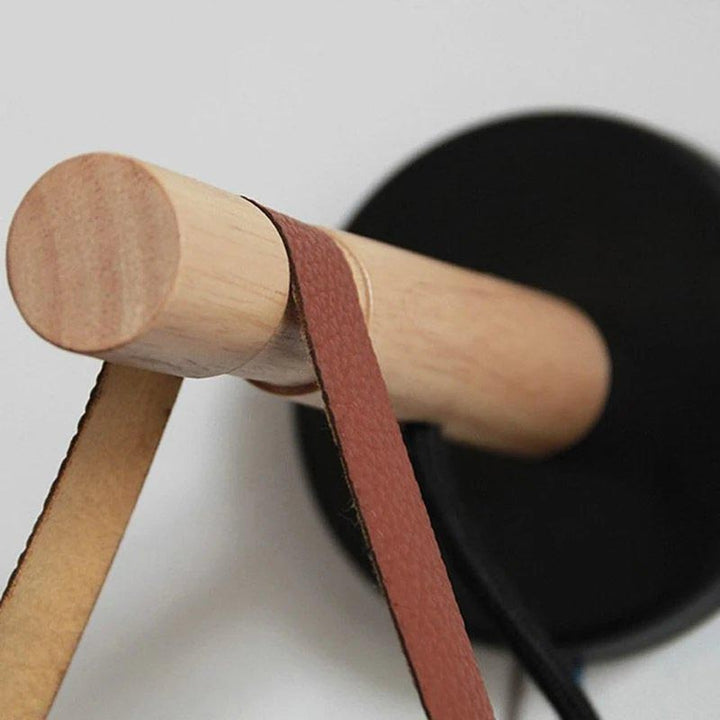 Wooden mallet with a red leather strip on a light gray background