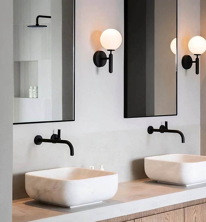 Two black MAELKEBOLD modern glass ball wall lights, Nordic LED sconces in a bathroom