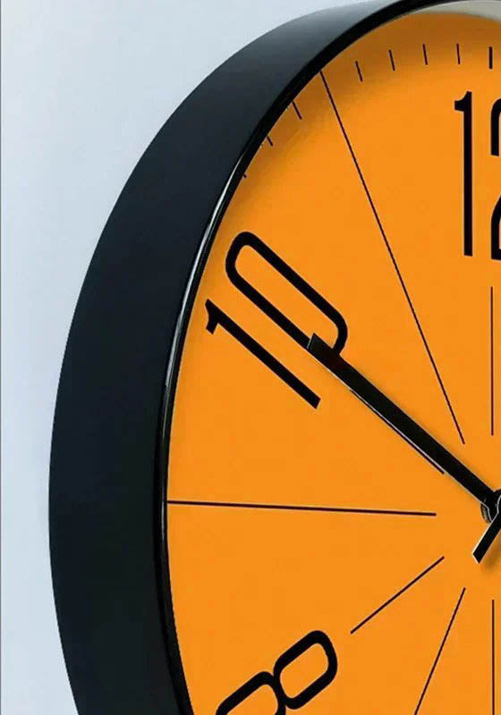 Detail of Nordic wall clock showing black metal frame and minimal face – contemporary silent timepiece for UK Scandinavian interiors.