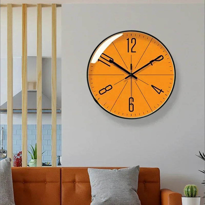 Stylish Orange Modern Wall Clock displayed in Scandinavian living room – yellow face adds bold colour to calm minimalist space.