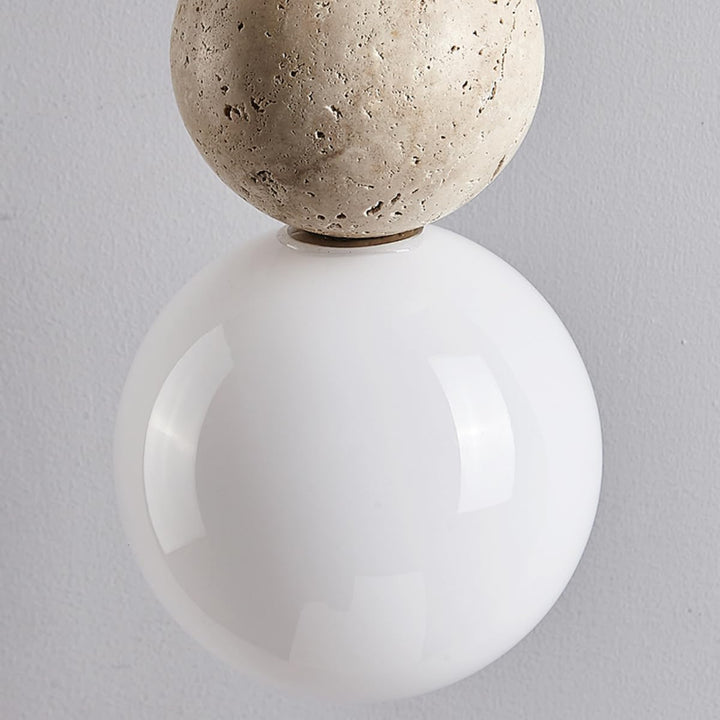 Wall-mounted light fixture with a spherical concrete top and white base on a gray background