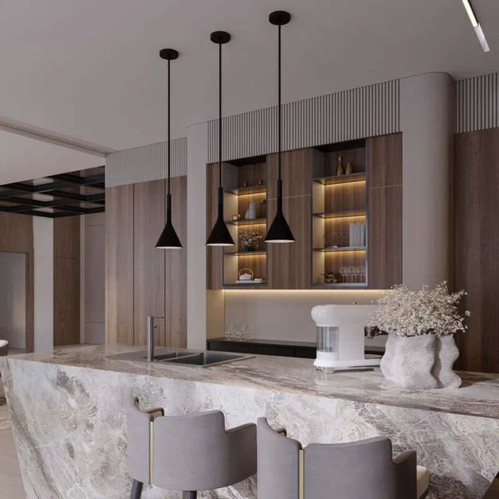 Modern kitchen with marble island, pendant lights, and wooden cabinets.