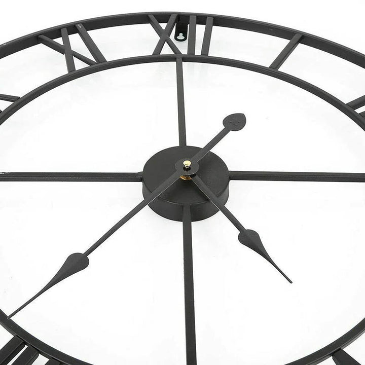 Black open-frame Roman numeral wall clock in matte metal, 40cm, close-up showing slim profile and modern design.