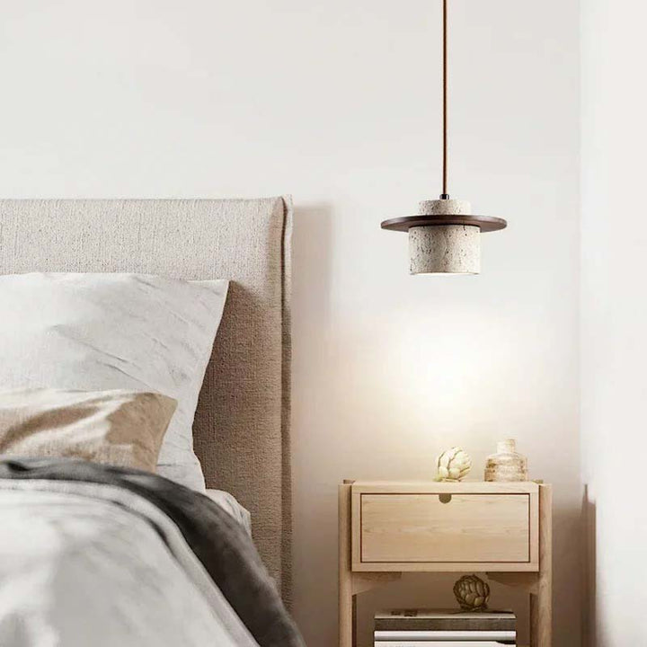 Bedroom with a bed, nightstand, and pendant light.