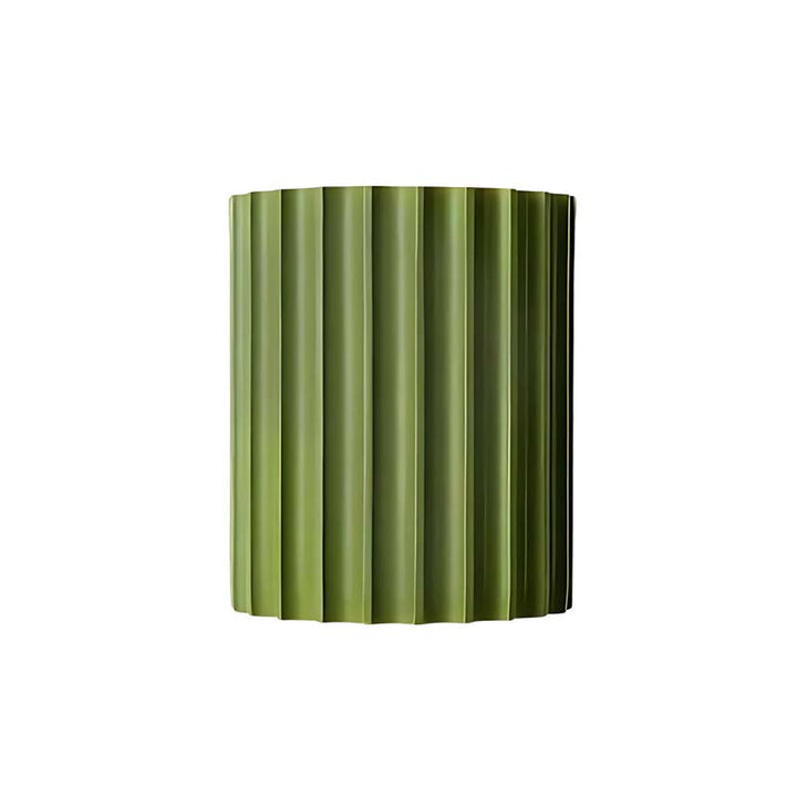 Green cylindrical vase with ribbed texture on a white background