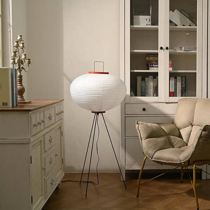Japandi tripod floor lamp with paper shade and wood handle, placed in calm hallway corner.