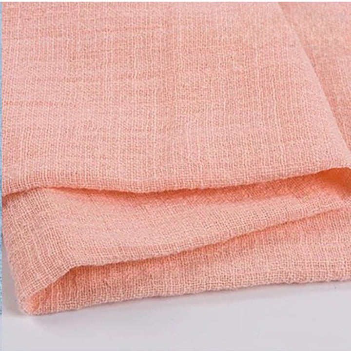 Folded pink cotton napkin for Weddings and Elegant uk Dining Decor on the white table.