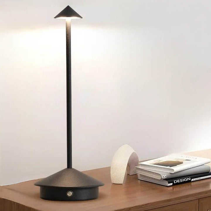 A sleek gray portable LED table lamp with a triangular shade and a circular base, powered by a USB cable.
