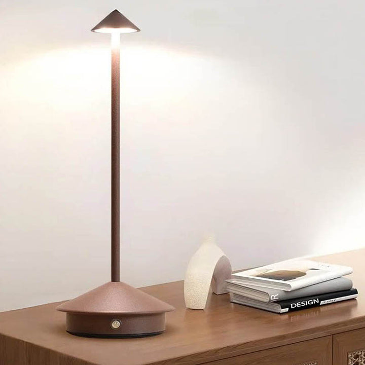 A sleek gray portable LED table lamp with a triangular shade and a circular base, powered by a USB cable.