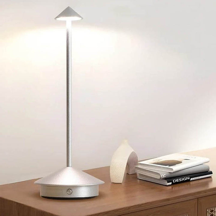 A sleek gray portable LED table lamp with a triangular shade and a circular base, powered by a USB cable.