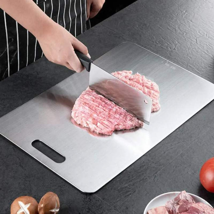 Chopping raw meat on stainless steel cutting board – sturdy, safe, and easy-to-clean food prep board